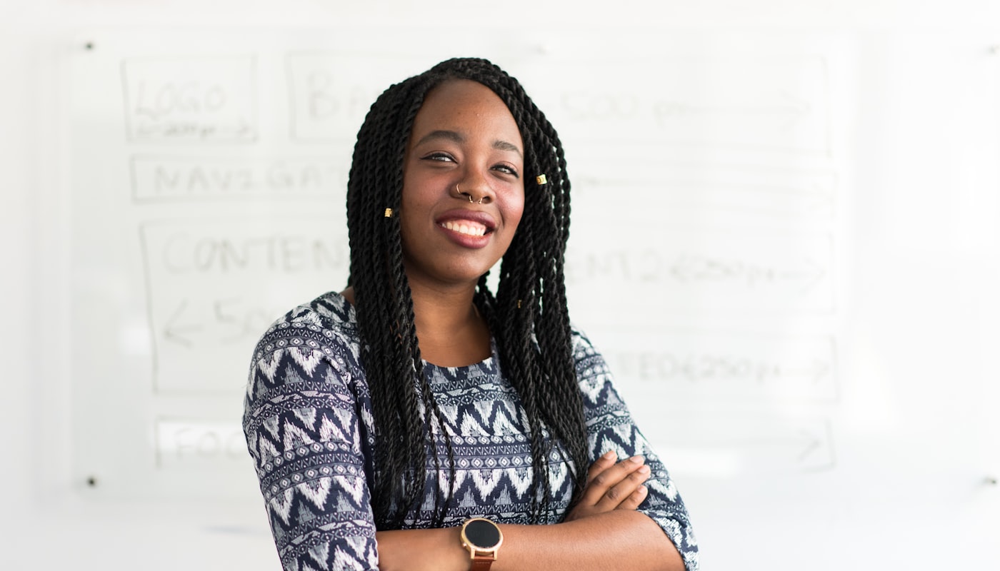 A confident young woman standing with her arms folded