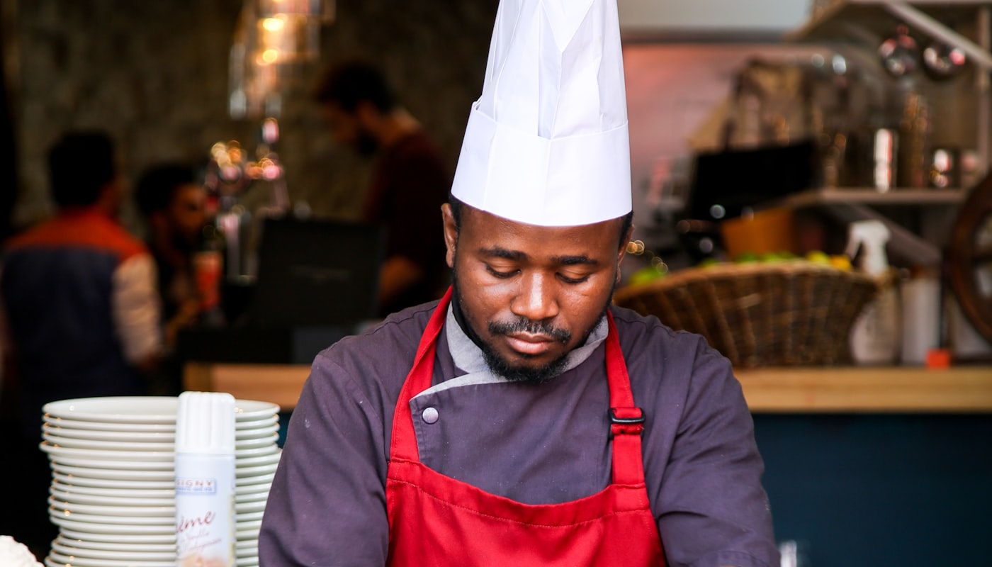 A chef plating a dish in a professional kitchen
