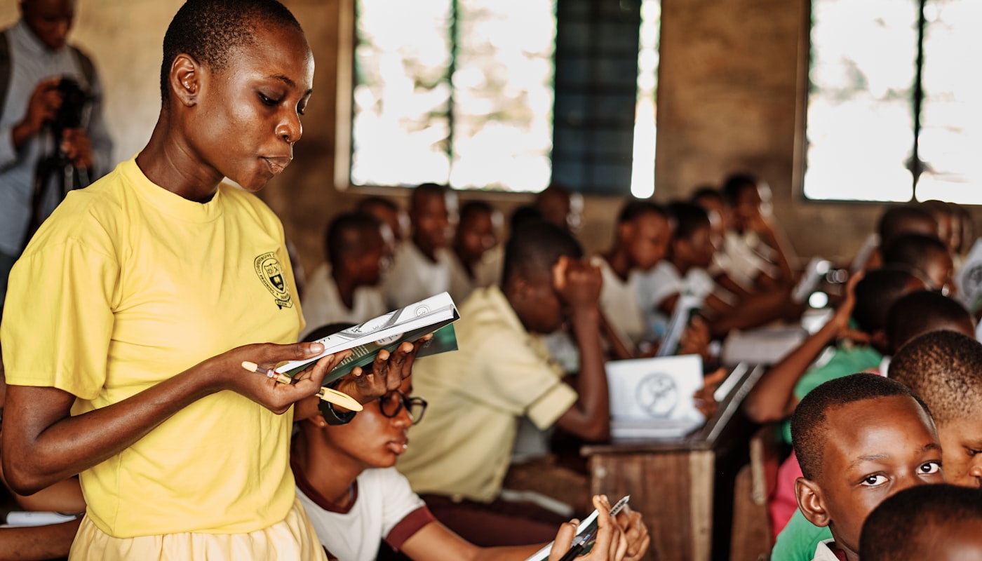 A volunteer teaching a class of children